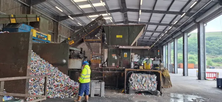 Team member in full PPE on a recycling site